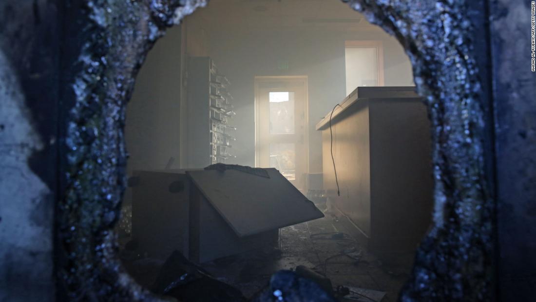 A picture taken through a broken window shows a vandalized room in the embassy.