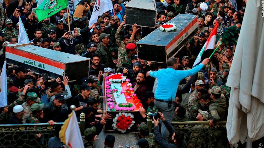 Mourners carry the coffins of Iranian-backed paramilitary fighters in Najaf, Iraq, on December 31. The fighters were killed in US airstrikes on Sunday that sparked Tuesday's attacks on the US Embassy in Baghdad.