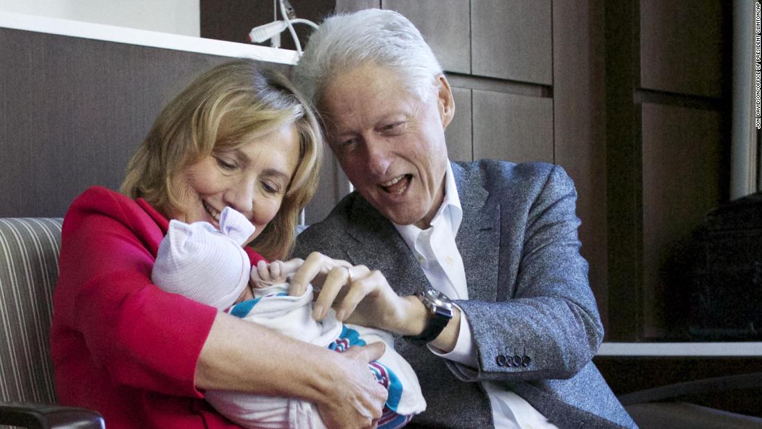 The Clintons hold their granddaughter, Charlotte, at a New York hospital in September 2014.