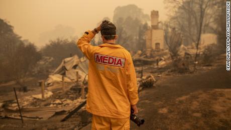 ABC photographer Matt Roberts reacts to seeing his sister&#39;s house destroyed by a bushfire in New South Wales, Australia.
