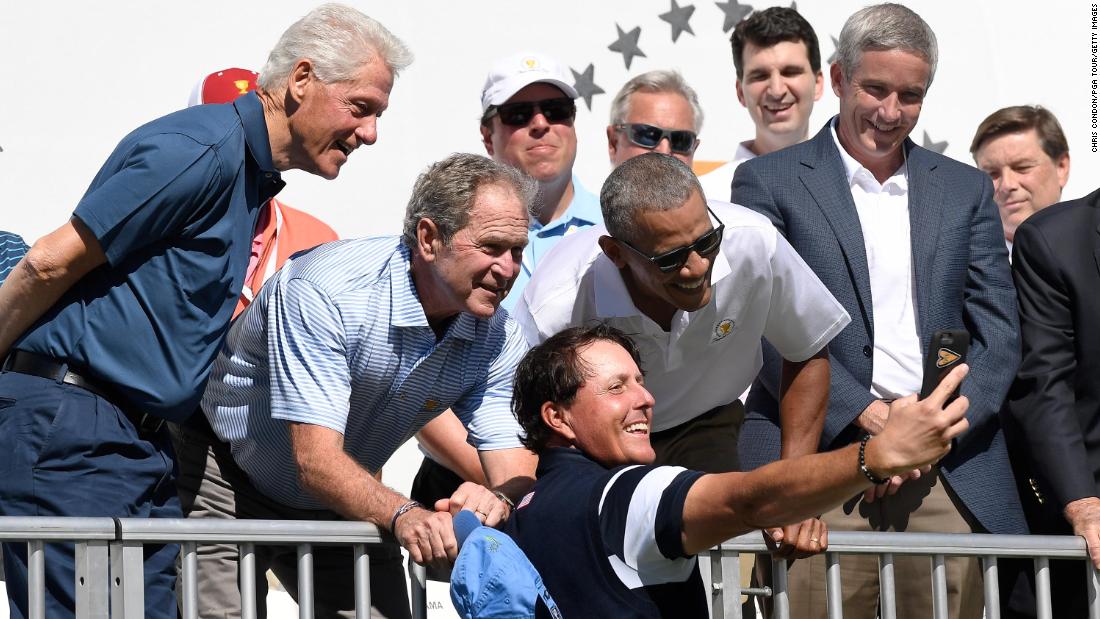 Clinton and former Presidents George W. Bush and Barack Obama pose for a selfie with golfer Phil Mickelson during the Presidents Cup event in September 2017.