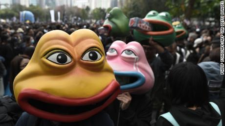 Activists wear Pepe the Frog masks, a character used by pro-democracy activists as a symbol of their struggle, as they gather in Victoria Park in the Causeway Bay area ahead of a planned pro-democracy march in Hong Kong on January 1, 2020. 