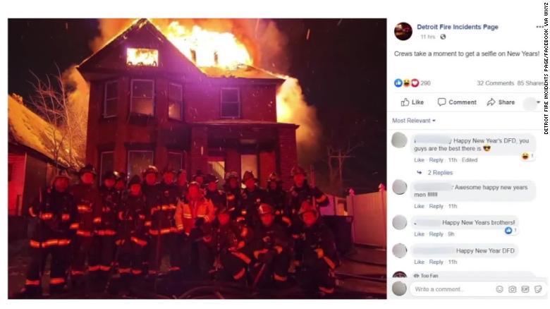 Detroit firefighters pose in front of a burning building in a photo that was later taken down by the Detroit Fire Incidents Page on Facebook. Although it isn't clear when it was taken, the initial caption was "Crews take a moment to get a selfie on New Years!"