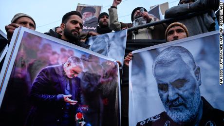 Protesters shout slogans against the United States and Israel as they hold posters with the image of top Iranian commander Qasem Soleimani, who was killed in a US airstrike in Iraq.