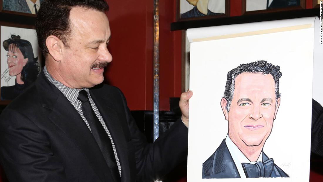 Hanks looks at his caricature after it was unveiled at Sardi&#39;s restaurant in New York in 2013.