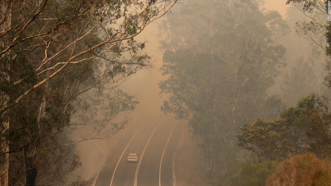 Smoke from wildfires shrouds a road near Moruya, Australia, on January 4.