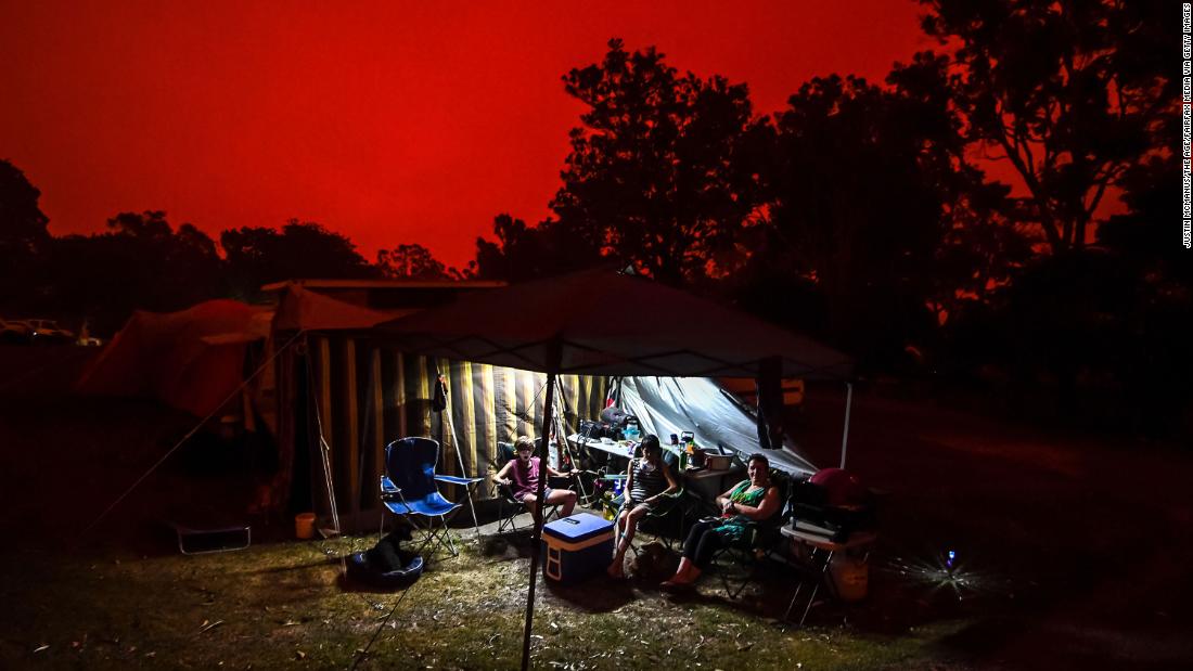 The sky turns red during the day in Mallacoota, Australia. People in the Foreshore Caravan Park are staying through what will be a day of severe fire conditions with large fires still burning out of control to the north of the town. 