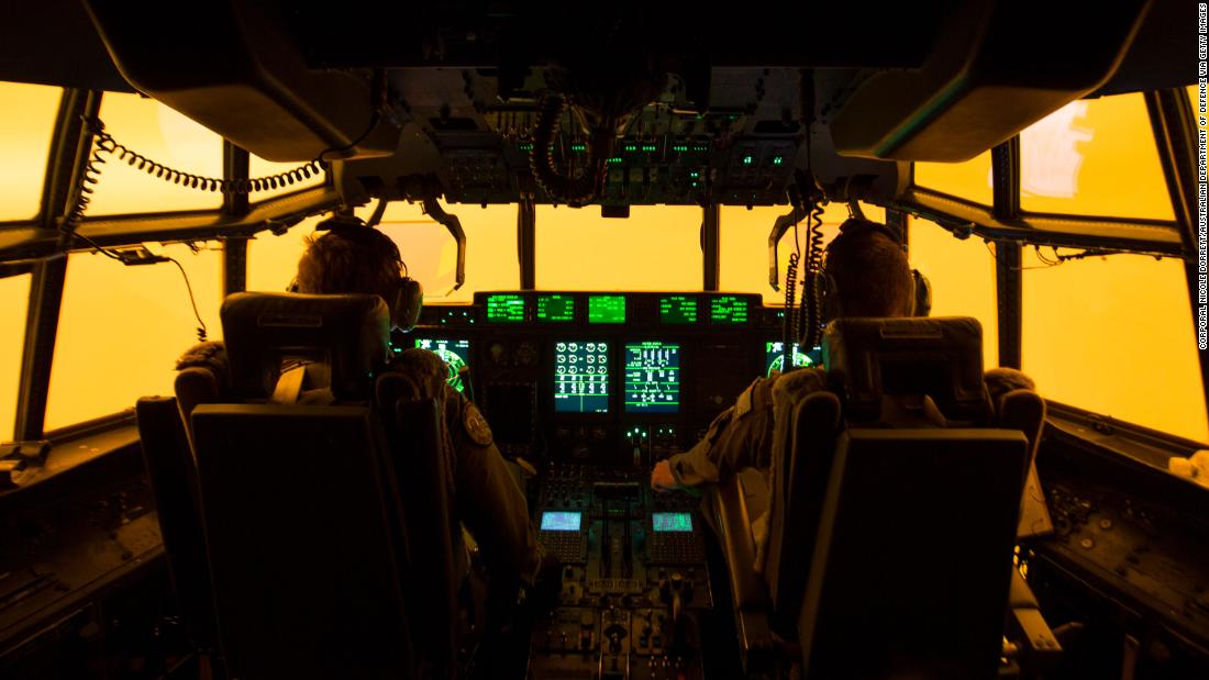 The flight deck of a C-130J Hercules is lit by the red glow of the fires below as the aircrew attempts to land in Merimbula to drop off fire and rescue crews to assist fighting the bushfires on Sunday, January 5.