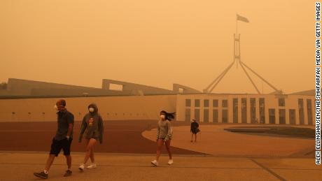 Visitors to Parliament House were forced to wear face masks after smoke from bushfires blankets Canberra in a haze on January 5.