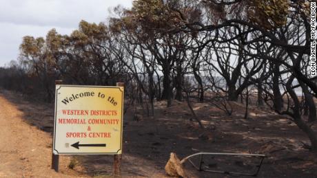 A sign stands next to burned land in Kangaroo Island