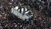 Iranian revolutionary guards surround the coffins of slain Iranian military commander Qasem Soleimani, Iraqi paramilitary chief Abu Mahdi al-Muhandis and other victims of a US attack as mourners gather to pay homage in the capital Tehran on January 6, 2020. - Mourners packed the streets of Tehran for ceremonies to pay homage to Soleimani, who spearheaded Iran's Middle East operations as commander of the Revolutionary Guards' Quds Force and was killed in a US drone strike on January 3 near Baghdad airport.