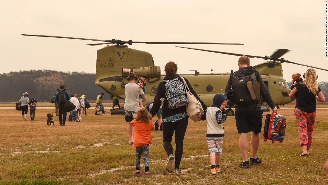 Families are evacuated by air from Mallacoota on January 5. 