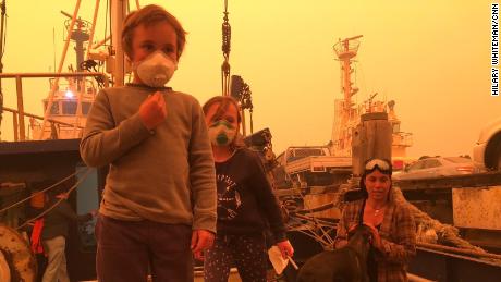 Ike, 5, and his sister Kalani, 6, with their mother Louise during a tense weekend on the family&#39;s fishing vessel where they took shelter from flames in Eden, NSW.