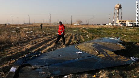 A rescue worker searches the scene where a Ukrainian plane crashed in Shahedshahr southwest of the capital Tehran, Iran, Wednesday, Jan. 8, 2020. A Ukrainian airplane carrying 176 people crashed on Wednesday shortly after takeoff from Tehran&#39;s main airport, killing all onboard. 