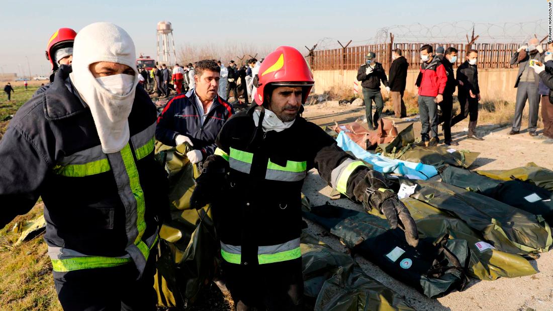 Recovery crews carry the body of a victim.