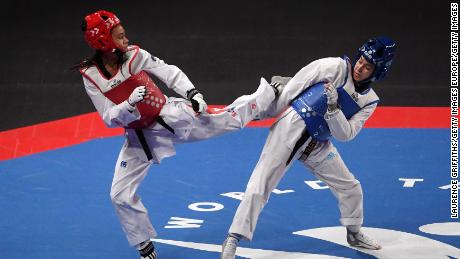 Aaliyah Powell (right) dodges a kick from Morocco&#39;s Oumaima El Bouchti on her way to winning bantamweight gold at the 2019 World Taekwondo Championships.