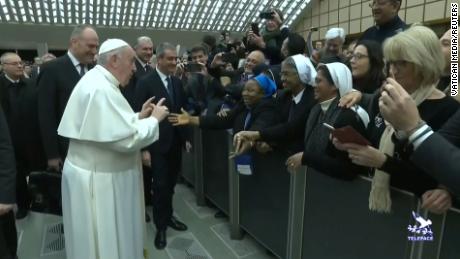 Pope Francis gestures as he jokes to a nun &quot;You bite! I will give you a kiss but you stay calm. Don&#39;t bite!&quot;