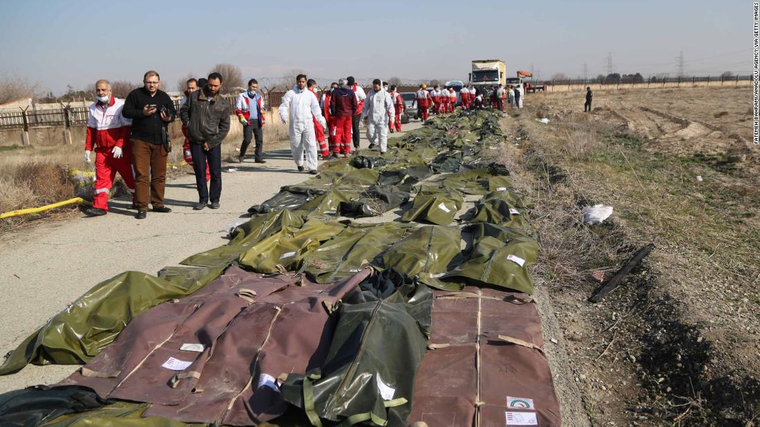 Body bags are laid out at the crash site.