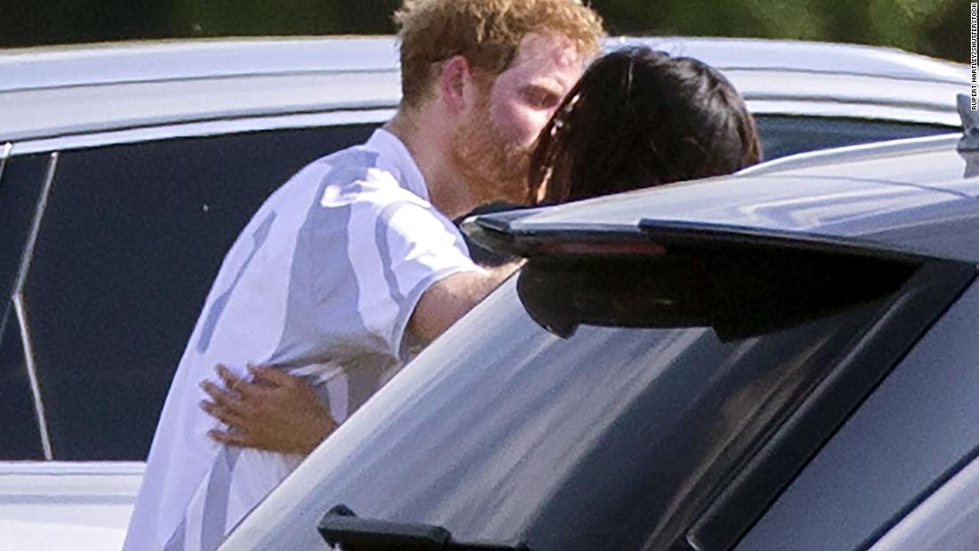 Harry and Meghan embrace at a polo match in May 2017. They were introduced by mutual friends in 2016.
