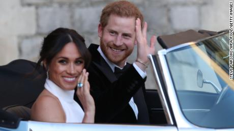 WINDSOR, UNITED KINGDOM - MAY 19: Duchess of Sussex and Prince Harry, Duke of Sussex wave as they leave Windsor Castle after their wedding to attend an evening reception at Frogmore House, hosted by the Prince of Wales on May 19, 2018 in Windsor, England. (Photo by Steve Parsons/WPA Pool/Getty Images)