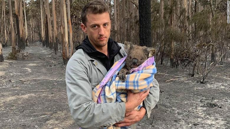 Jack Bruce holds Wilbur, a koala rescued from the fires, who he and his partner Alyex Burges are helping rehome. 