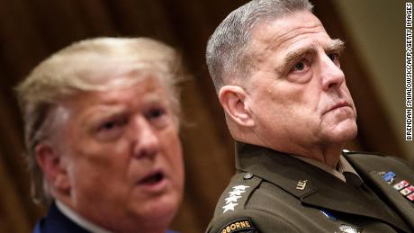 Chairman of the Joint Chiefs of Staff Army General Mark A. Milley (R) listens while US President Donald Trump speaks before a meeting with senior military leaders in the Cabinet Room of the White House in Washington, DC on October 7, 2019. 