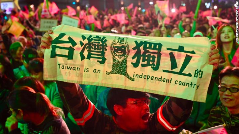 A supporter of Taiwan President Tsai Ing-wen displays a banner outside the campaign headquarters in Taipei on January 11, 2020.