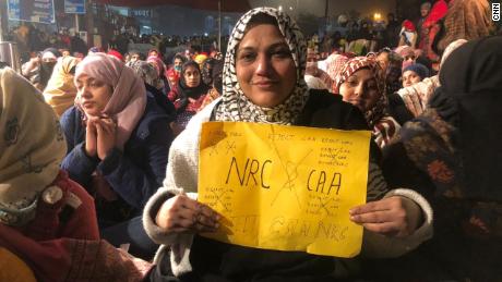 A woman holds a protest sign on December 27, 2019, at Shaheen Bagh, a neighborhood in the Indian capital of New Delhi where women have been staging a peaceful sit in. 