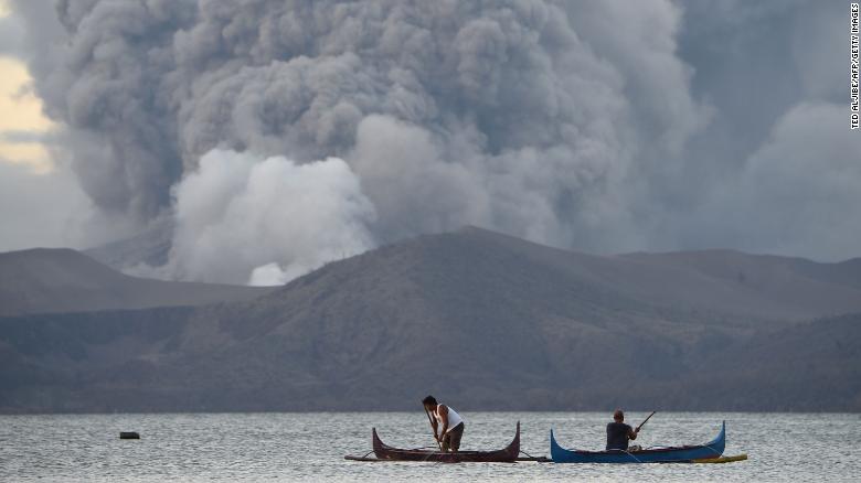 Residents living along Taal lake catch fish as Taal volcano erupts in Tanauan town.