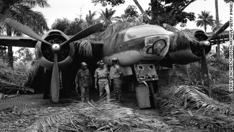 Soldiers posing in front of a captured plane, during the Nigerian conflict with Biafran forces, Nigeria, 1968. 
