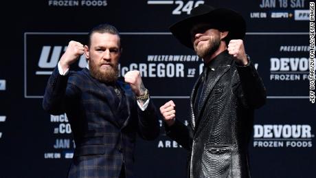 McGregor and Donald Cerrone pose for photos during the UFC 246 press conference.