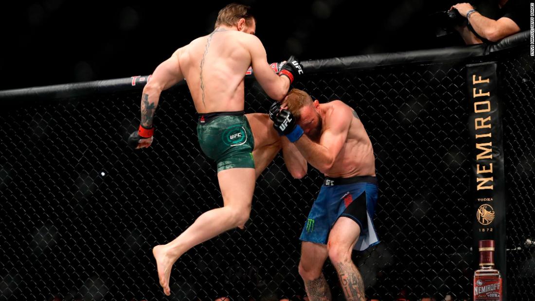 McGregor lands a knee to the face of Cerrone. McGregor blitzed Cerrone from the opening bell and won the fight less than a minute into the first round.