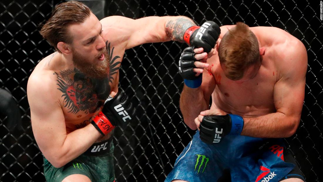 McGregor hits Cerrone during their UFC 246 welterweight mixed martial arts bout. 