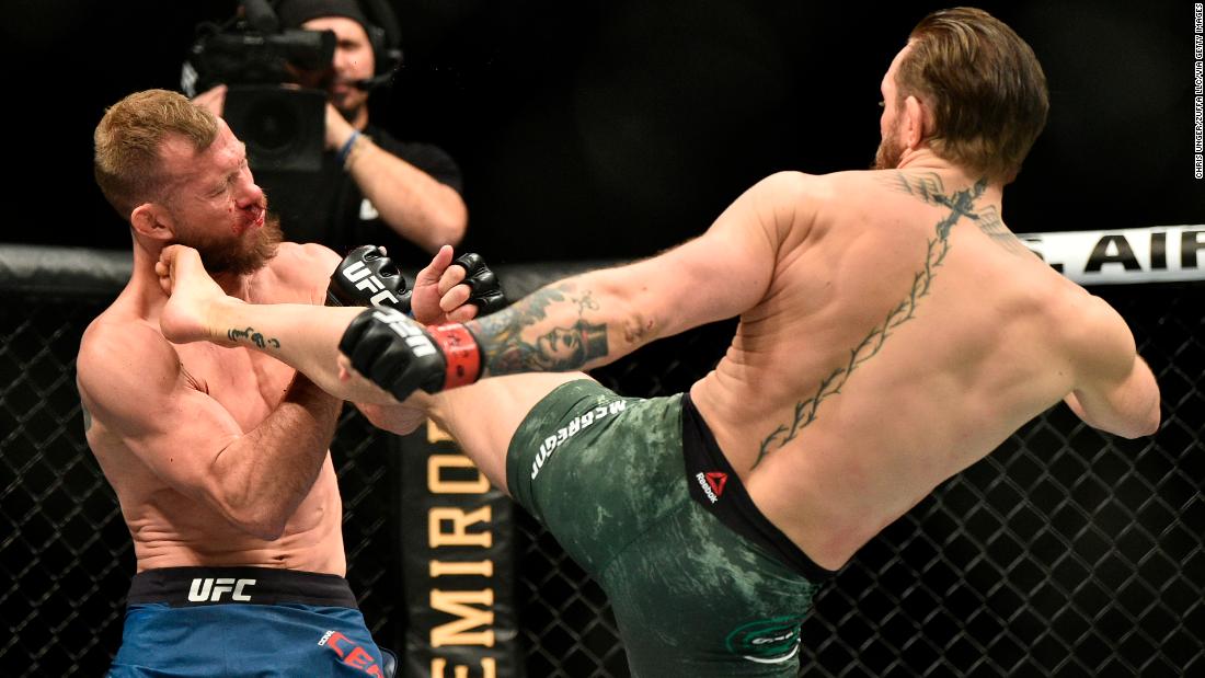 McGregor kicks Cerrone in the face. 