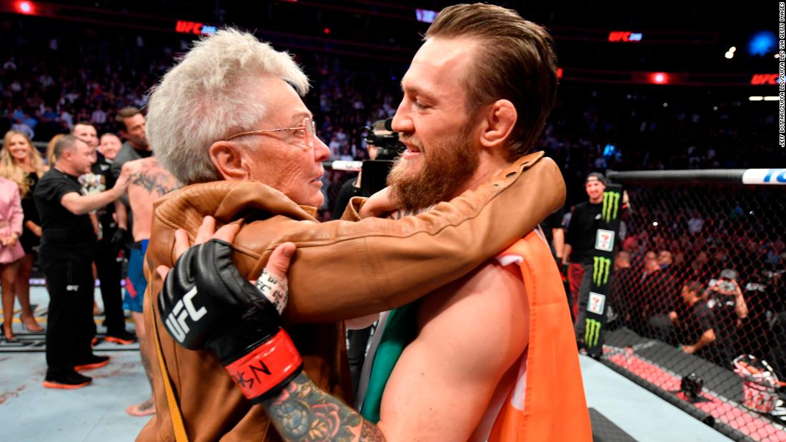 Conor McGregor is hugged by Jerry Cerrone, the grandmother of Donald Cerrone, after the bout.