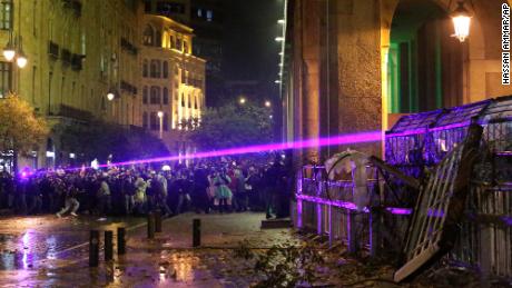 Anti-government protesters use lasers as they clash with the riot police.