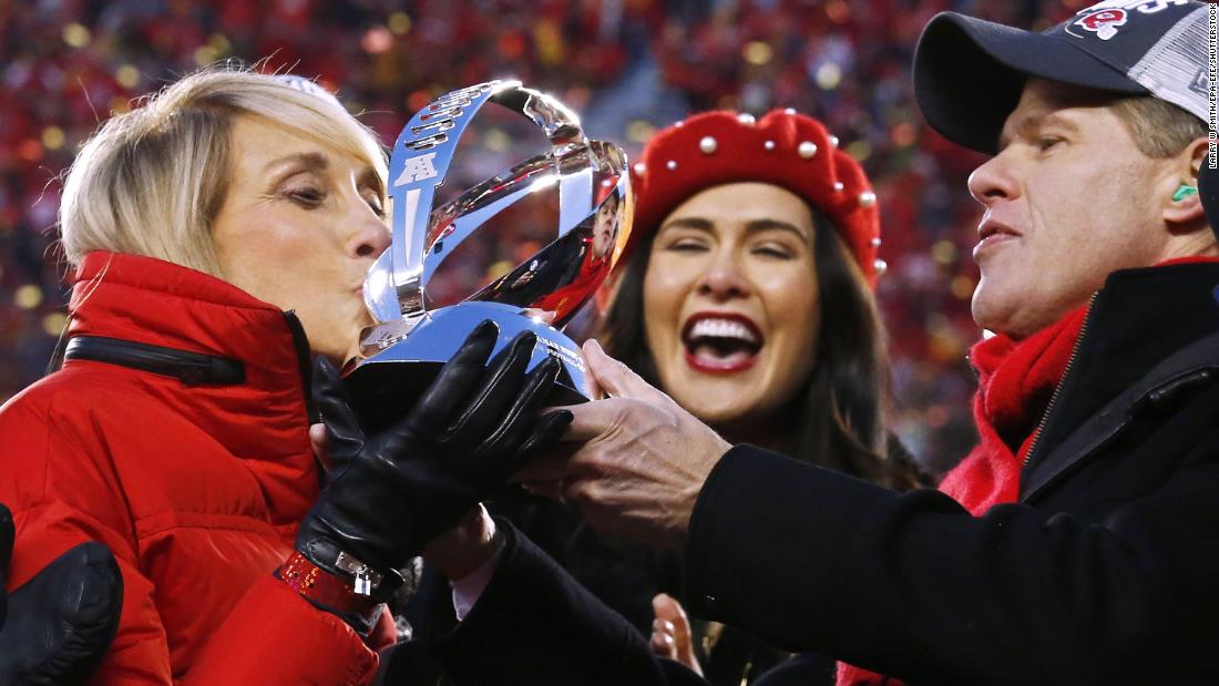 Kansas City Chiefs chairman and CEO Clark Hunt holds the Lamar Hunt Trophy for his mother Norma Hunt, the widow of former owner Lamar Hunt, while she kisses it on stage after the Chiefs beat the Tennessee Titans in their AFC Championship game at Arrowhead Stadium in Kansas City, Missouri.