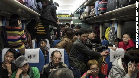 This photo taken on February 10, 2018 shows passengers travelling on a crowded train during the 26-hour journey from Beijing to Chengdu, as they head home ahead of the Lunar New Year.
