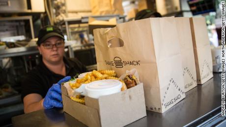 NEW YORK, NY - AUGUST 18:  Shake Shack workers prepare orders on August 18, 2014 in Madison Square Park in New York City. Shake Shack is allegedly considering going public and holding an initial price offering (IPO).  (Photo by Andrew Burton/Getty Images)