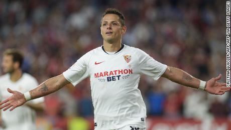 Sevilla&#39;s Mexican forward Chicharito celebrates after scoring a goal during the Spanish league football match between Sevilla FC and Getafe CF at the Ramon Sanchez Pizjuan stadium in Seville on October 27, 2019. (Photo by CRISTINA QUICLER / AFP) (Photo by CRISTINA QUICLER/AFP via Getty Images)