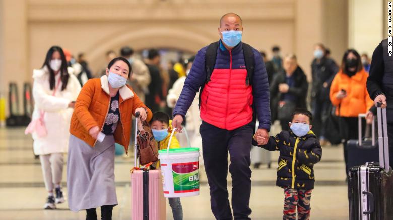 Commuters wearing face masks walk in Hankou railway station in Wuhan, where China&#39;s coronavirous outbreak first emerged last month.