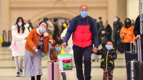 Commuters wearing face masks walk in Hankou railway station in Wuhan, where China&#39;s coronavirous outbreak first emerged last month.
