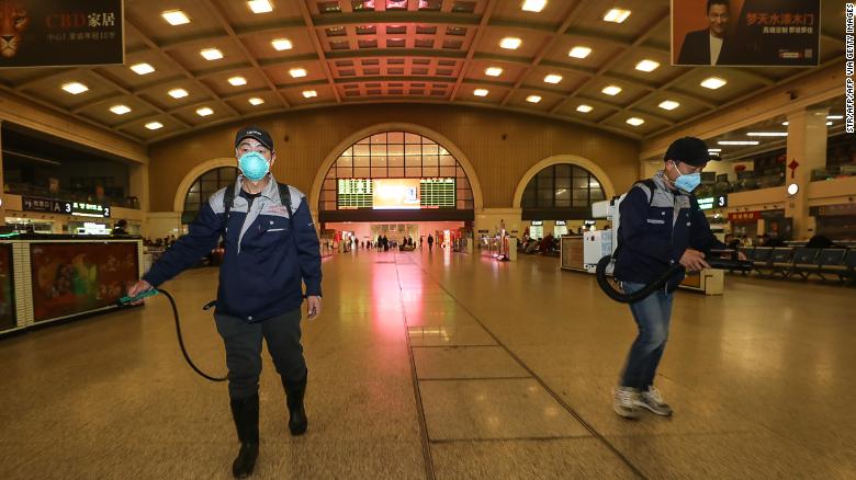 Staff members disinfect the Hankou Railway Station in Wuhan on Wednesday.