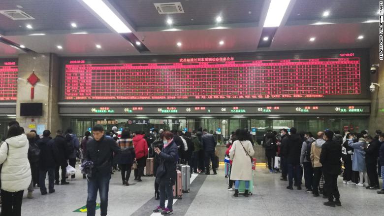 Commuters wait in line at Wuchang railway station in Wuhan on Wednesday.