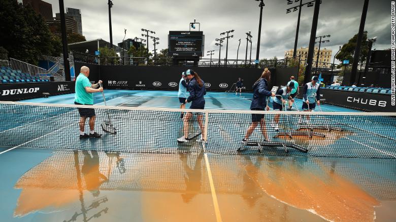 Staff cleaning dirt off the outside courts at Melbourne Park on January 23, 2020 in Melbourne, Australia.