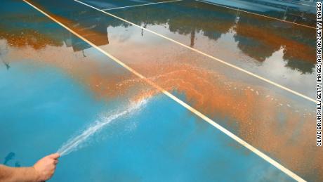 High-pressure cleaning was required to clear the outside courts at Melbourne Park. 