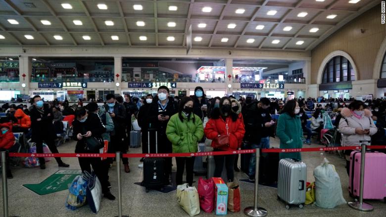 Travelers at Wuhan&#39;s Hankou railway station queue to leave the city early on Thursday morning before the citywide lockdown goes into effect.