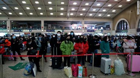 Travelers at Wuhan&#39;s Hankou railway station queue to leave the city early on Thursday morning before the citywide lockdown goes into effect.