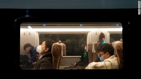 Passengers wearing face masks onboard one of the last trains to leave Wuhan before a citywide lockdown came into effect.