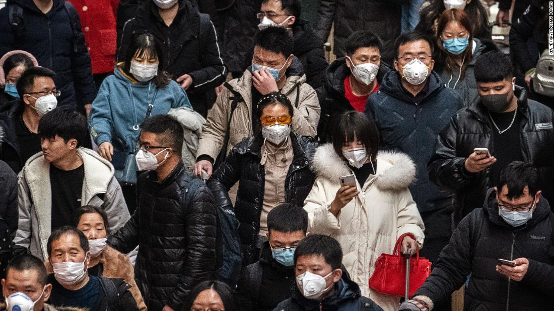 Passengers wear protective masks at a Beijing railway station on January 23.